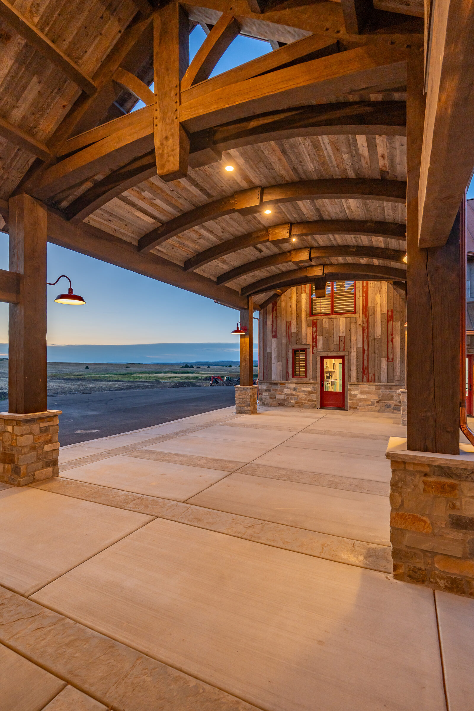 Covered porch with reclaimed timber arches