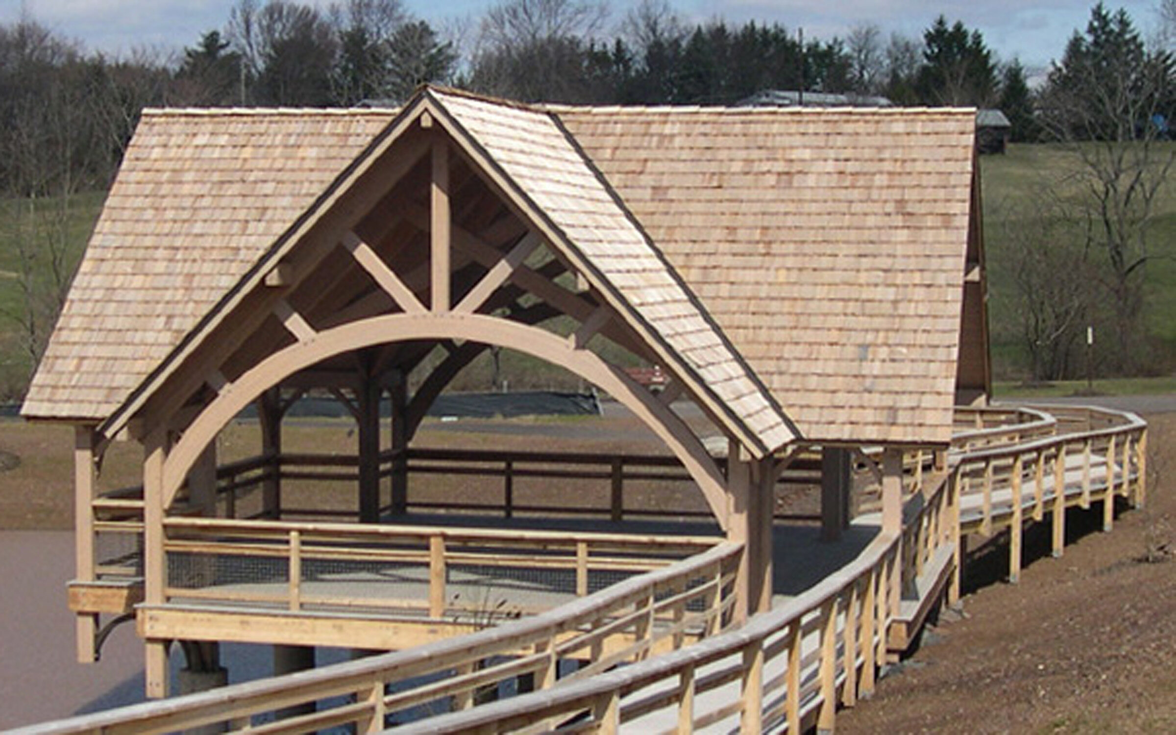 Cedar-shake pavilion with curved timber arch